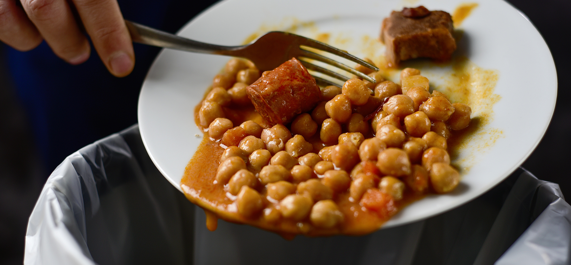 Image of food being scrapped into the bin